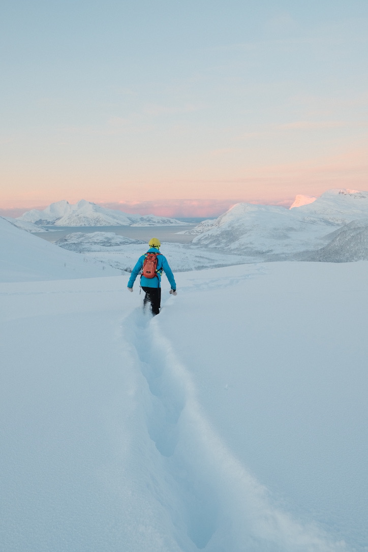 A walker following a trail through deep snow